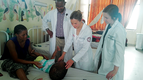 Dr. Shabani, Dr. Hoffman, and Dr. Tomasiewicz at patient bedside, Tanzania 2018