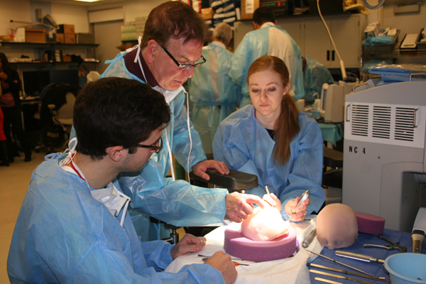 Dr. Spinelli instructs participants in surgical techniques