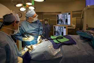 Dr Hartl monitors surgery using a 3D intraoperative navigation system
