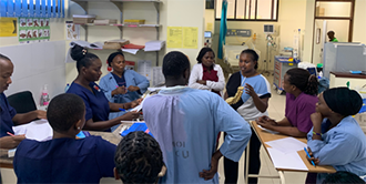Global Fellow Dr. Beverly Cheserem training local medical staff in Tanzania