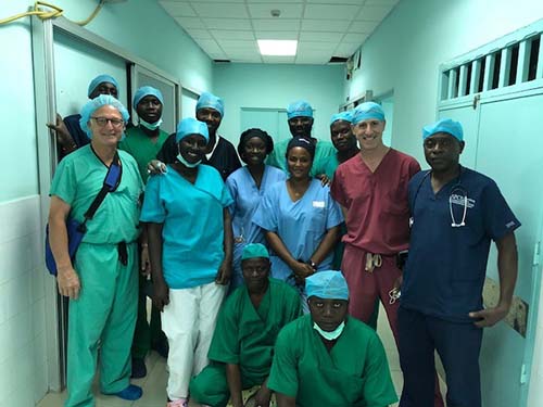 Dr. Stieg, Dr. Cisse, and Dr. Greenfield with the OR team at Fann Hospital